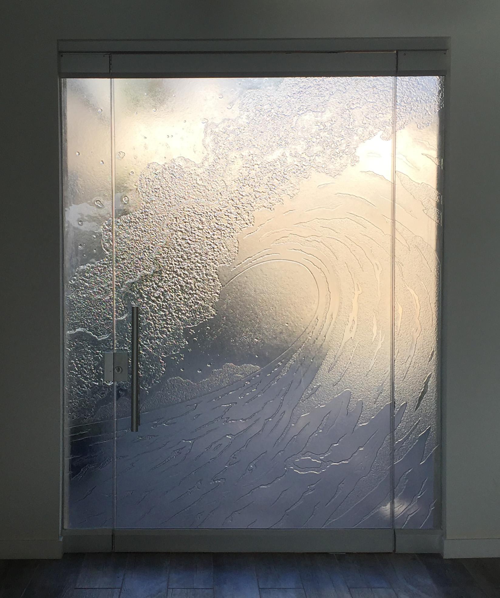 Cast glass entryway door with cresting wave motif