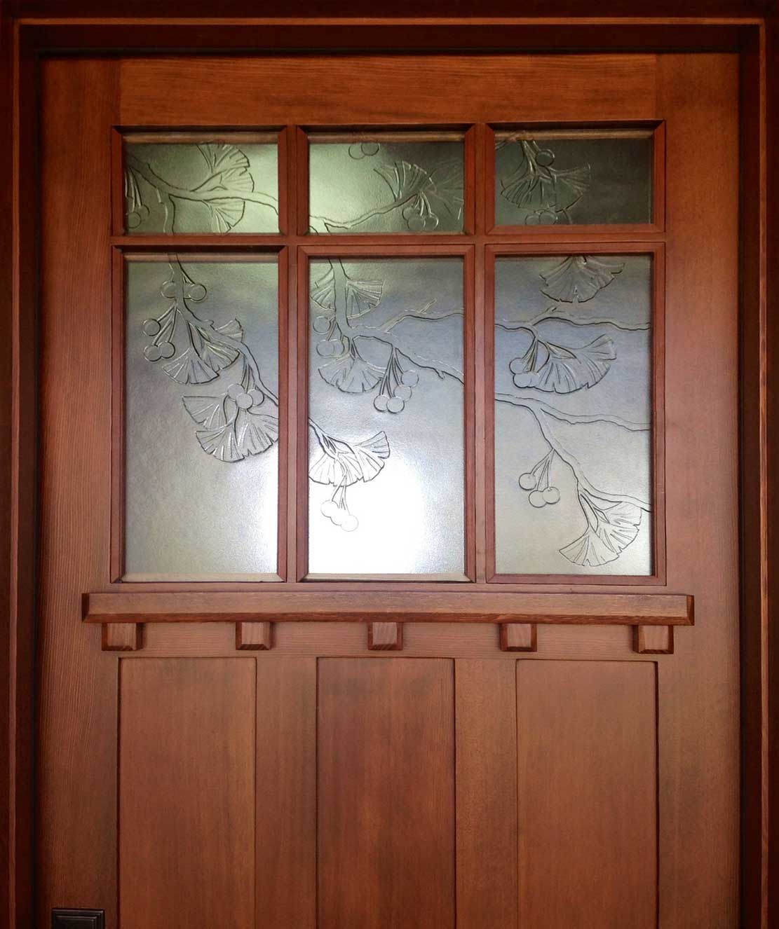 Wooden door with wave motif in cast glass