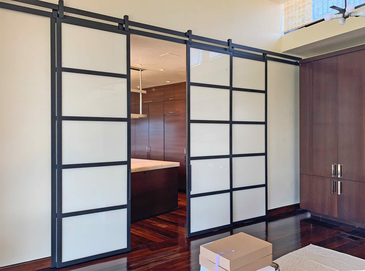 Large Metal and Glass Barn Doors Between Kitchen and Dining Room